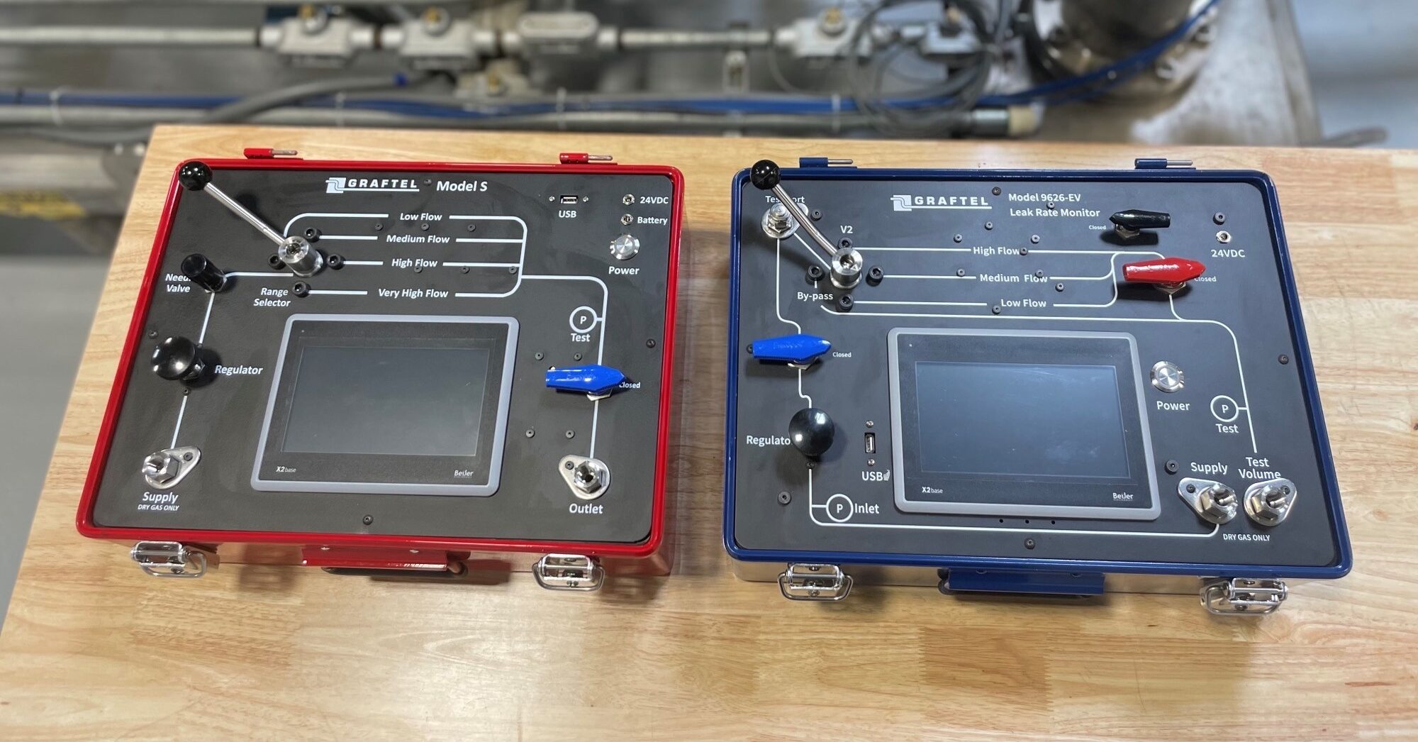 Graftel’s 9623 Model S LLRT flow standard (left) is used to calibrate other leak rate monitors that cannot leave site. Graftel’s current 9623 Model EV (right) with integrated air generator and internal battery operates with no power source.